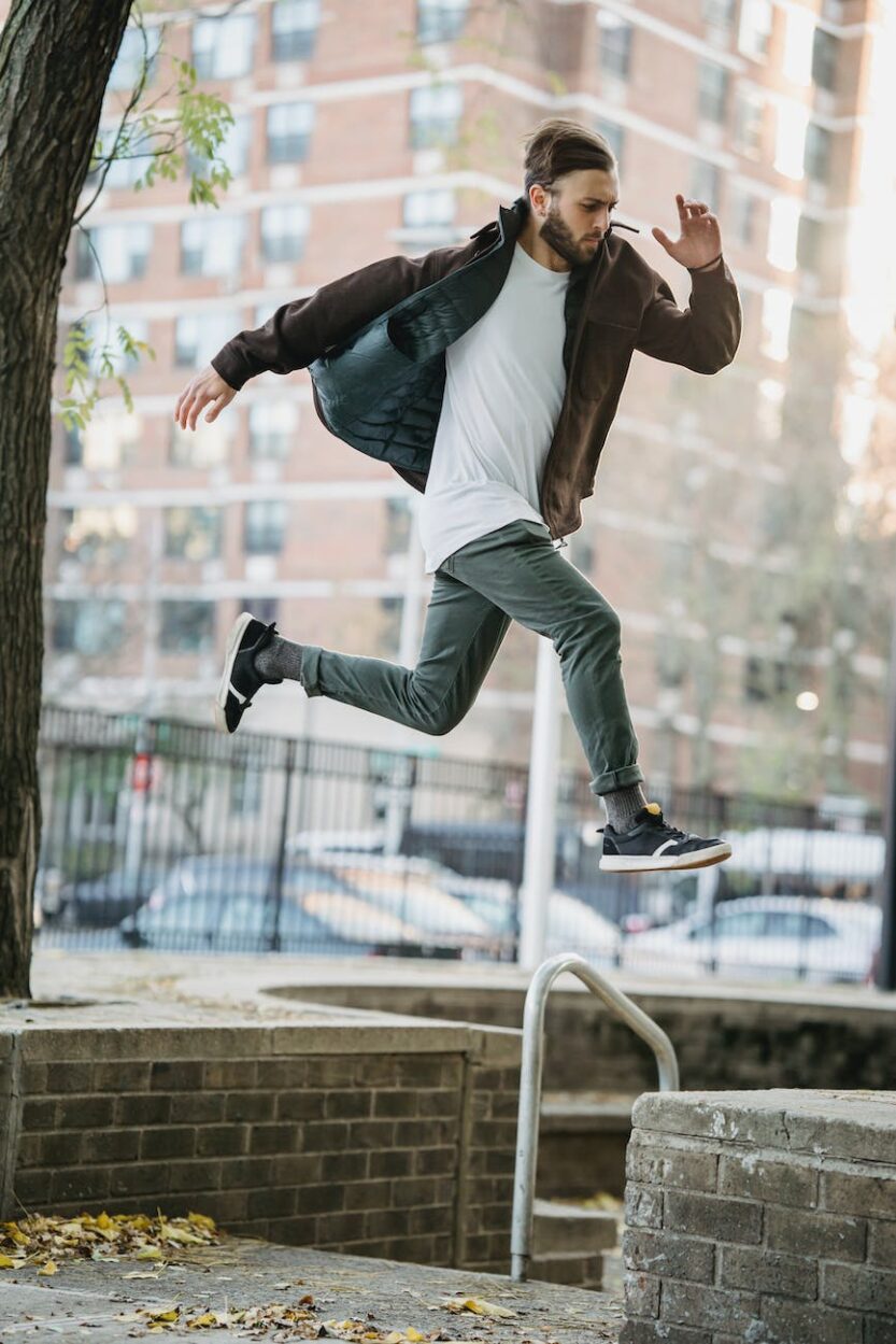 young man jumping on street